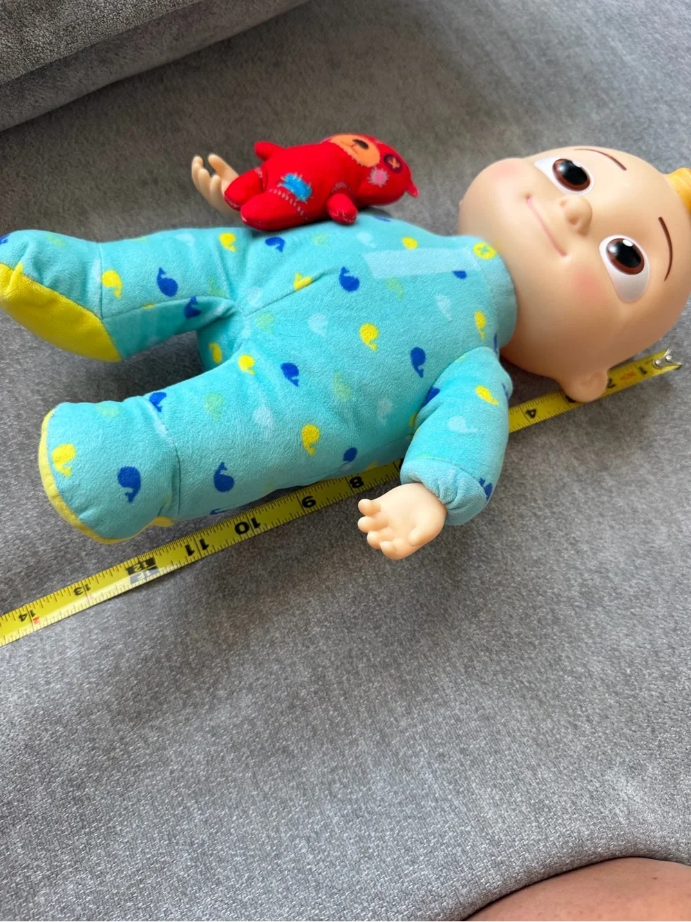 Cocomelon baby doll with blue/yellow duck pattern